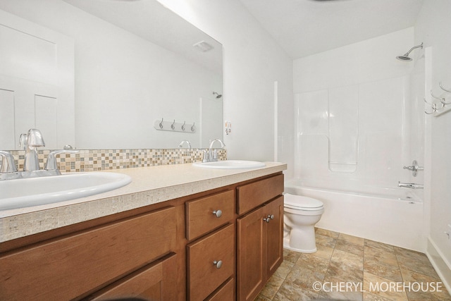 7511 Emerald Woods SE, Byron Center, MI 49315 - bathroom with double vanity,  shower combination, stone finish flooring, and backsplash