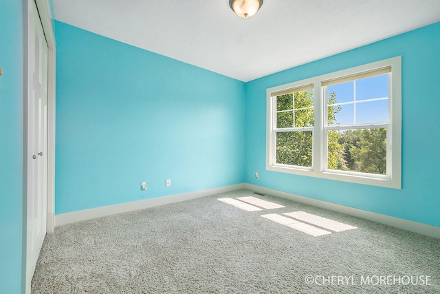 7511 Emerald Woods SE, Byron Center, MI 49315 - carpeted empty room featuring baseboards