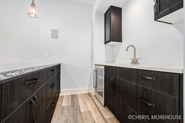 7511 Emerald Woods SE, Byron Center, MI 49315 - washroom featuring beverage cooler and light wood finished floors