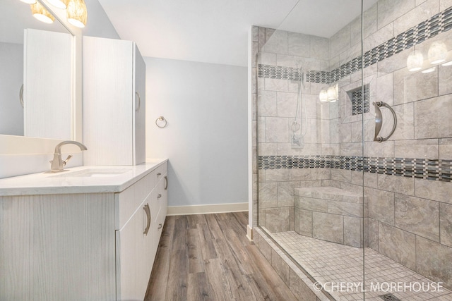 7511 Emerald Woods SE, Byron Center, MI 49315 - full bath with wood finished floors, vanity, and a stall shower
