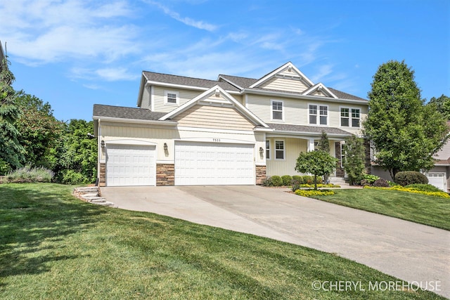 7511 Emerald Woods SE, Byron Center, MI 49315 - view of front of home featuring driveway, stone siding, a front yard, and an attached garage