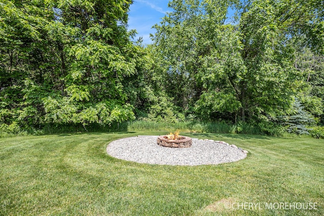7511 Emerald Woods SE, Byron Center, MI 49315 - view of green lawn featuring an outdoor fire pit
