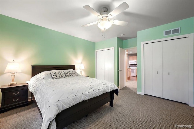 6280 Branford Dr, West Bloomfield, MI 48322 - bedroom featuring multiple closets, dark colored carpet, and ceiling fan