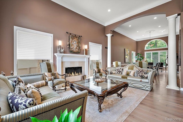 6280 Branford Dr, West Bloomfield, MI 48322 - living area featuring decorative columns, ornamental molding, arched walkways, recessed lighting, and a tiled fireplace