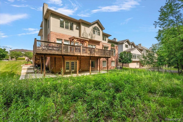 6280 Branford Dr, West Bloomfield, MI 48322 - back of house featuring a deck, a patio, brick siding, and a chimney