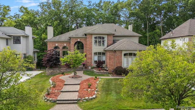 6280 Branford Dr, West Bloomfield, MI 48322 - traditional-style home with brick siding, a chimney, a front lawn, and a shingled roof