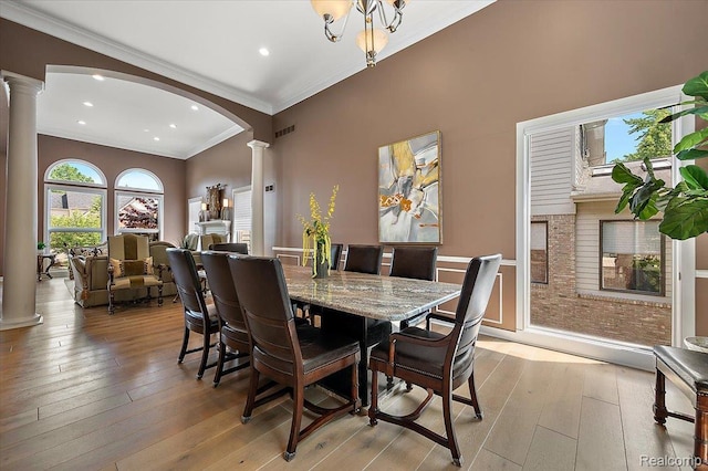 6280 Branford Dr, West Bloomfield, MI 48322 - dining space with ornate columns, crown molding, arched walkways, light wood-style flooring, and recessed lighting