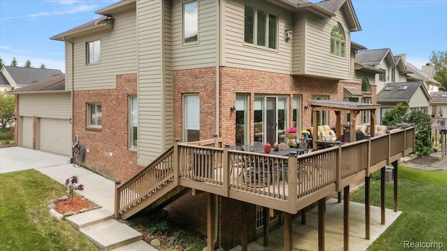 6280 Branford Dr, West Bloomfield, MI 48322 - back of property featuring brick siding, a deck, a yard, an attached garage, and concrete driveway