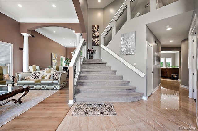 6280 Branford Dr, West Bloomfield, MI 48322 - staircase with ornate columns, arched walkways, recessed lighting, and ornamental molding