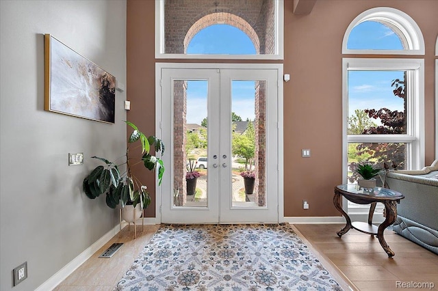 6280 Branford Dr, West Bloomfield, MI 48322 - foyer featuring wood finished floors, french doors, and a towering ceiling
