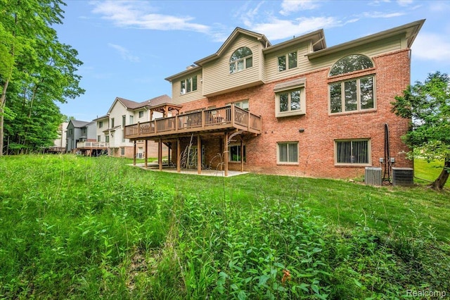 6280 Branford Dr, West Bloomfield, MI 48322 - rear view of house with a deck, a yard, and brick siding