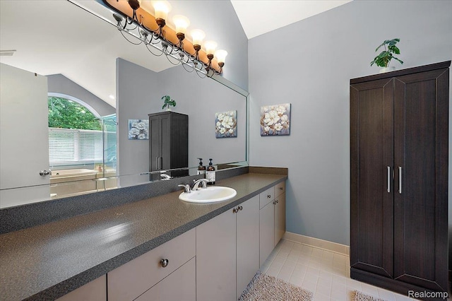 6280 Branford Dr, West Bloomfield, MI 48322 - bathroom with lofted ceiling, vanity, tile patterned flooring, and a tub to relax in
