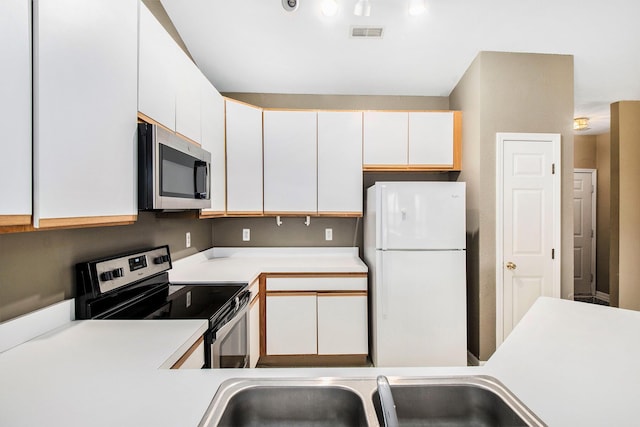 1377 Fox Pointe Cir, Ann Arbor, MI 48108 - kitchen featuring stainless steel appliances, light countertops, and white cabinetry