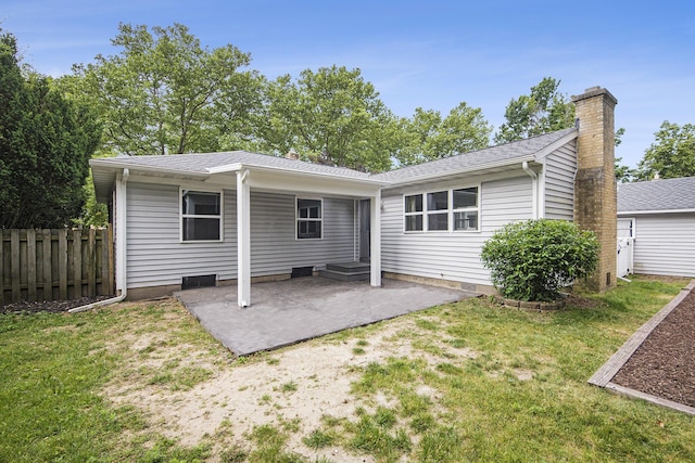 1915 Orville St SE, Grand Rapids, MI 49506 - rear view of house with a patio area, a chimney, and a shingled roof