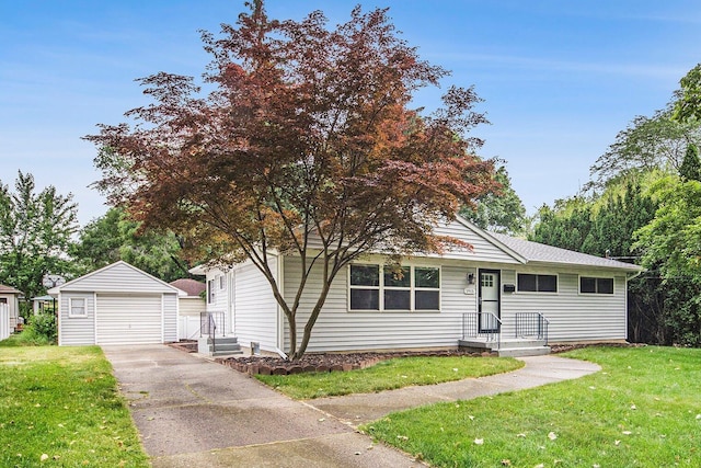 1915 Orville St SE, Grand Rapids, MI 49506 - view of front of home featuring an outdoor structure, a garage, a front lawn, and driveway