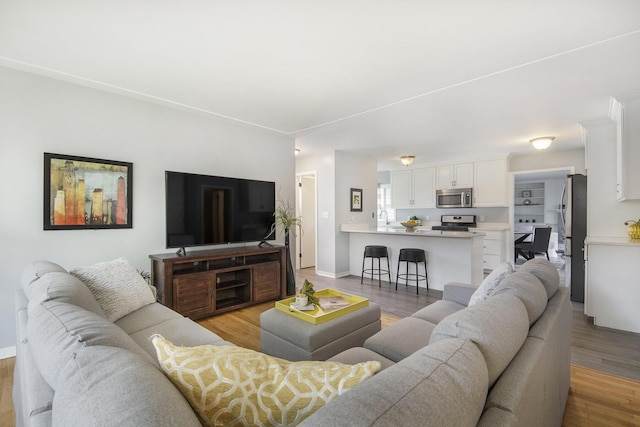 1915 Orville St SE, Grand Rapids, MI 49506 - living room with light wood-style floors and baseboards