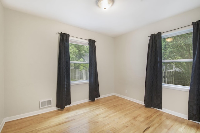 1915 Orville St SE, Grand Rapids, MI 49506 - unfurnished room featuring wood finished floors and baseboards