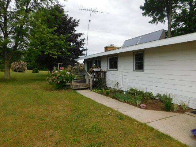 3509 E Taylor Rd, Hart, MI 49420 - view of green lawn featuring a wooden deck