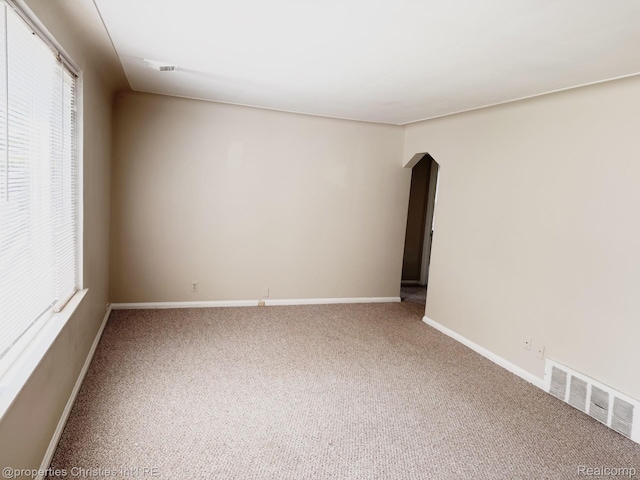 2343 Bonner St, Ferndale, MI 48220 - carpeted empty room featuring arched walkways and baseboards