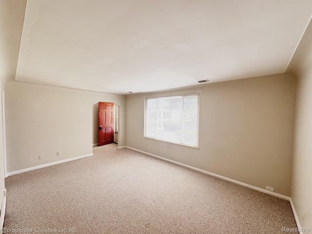 2343 Bonner St, Ferndale, MI 48220 - empty room featuring arched walkways and light colored carpet