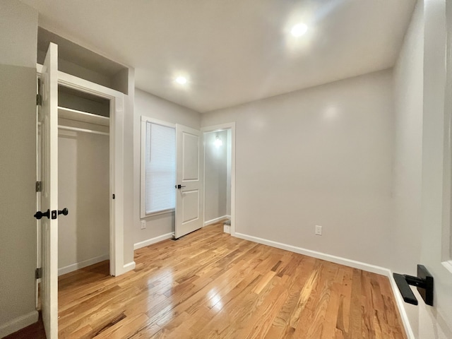 336 E Prospect St, Jackson, MI 49203 - unfurnished bedroom with light wood-style floors and recessed lighting
