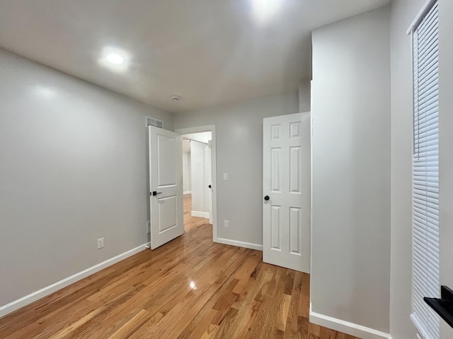 336 E Prospect St, Jackson, MI 49203 - unfurnished bedroom with baseboards and light wood-type flooring