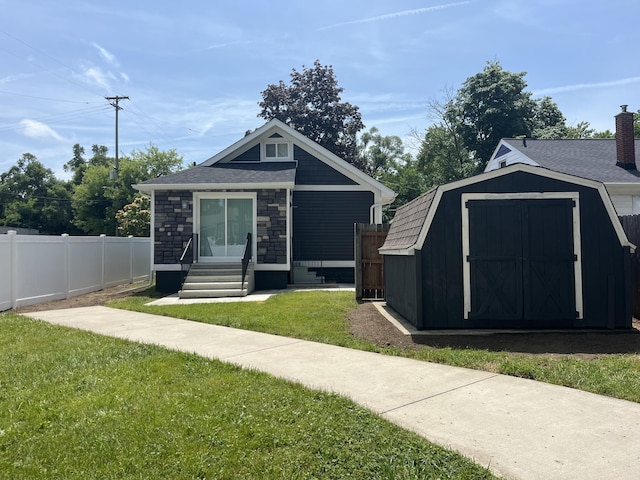 336 E Prospect St, Jackson, MI 49203 - view of front of property featuring a storage unit and stone siding