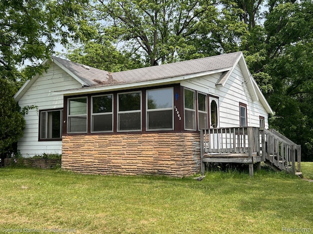 13063 Shaftsburg Rd S, Shaftsburg, MI 48872 - view of front facade with a front yard, stone siding, and roof with shingles