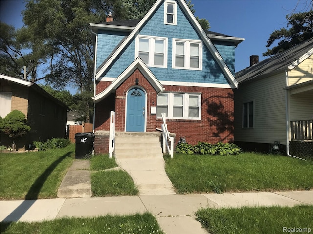 18522 Joseph Campau St, Detroit, MI 48234 - view of front of house featuring a front yard, brick siding, and a chimney