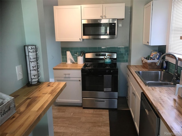 18522 Joseph Campau St, Detroit, MI 48234 - kitchen featuring wood counters, stainless steel appliances, and white cabinetry