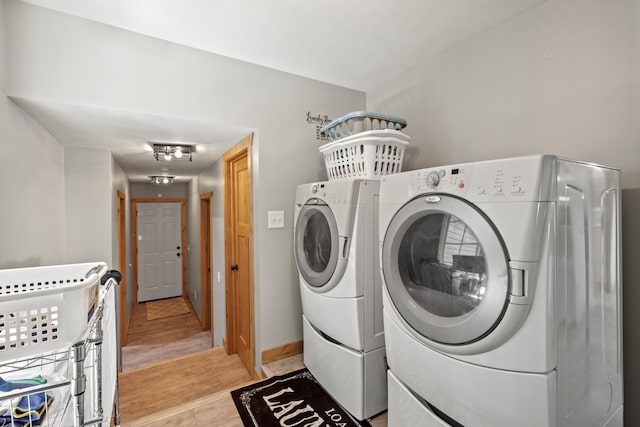 10456 Ferris Ave, Grant, MI 49327 - laundry room with washing machine and clothes dryer and baseboards