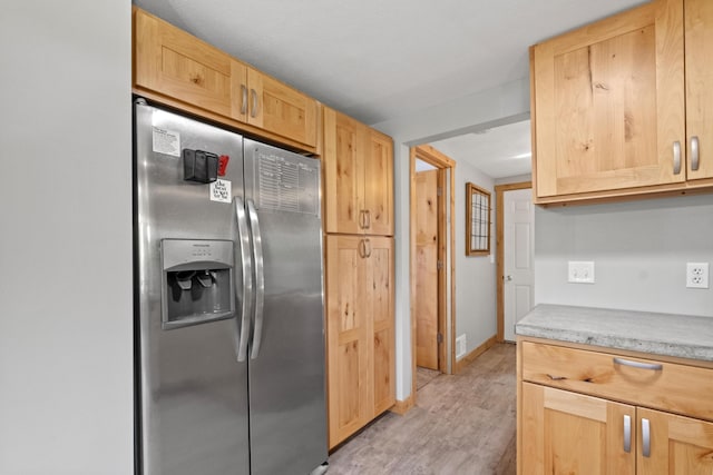 10456 Ferris Ave, Grant, MI 49327 - kitchen featuring stainless steel fridge, light brown cabinets, light wood-style floors, and light countertops