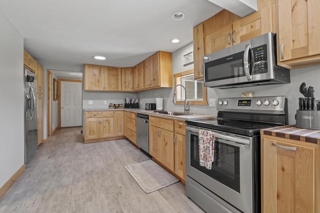 10456 Ferris Ave, Grant, MI 49327 - kitchen featuring stainless steel appliances, light brown cabinetry, light wood-style floors, recessed lighting, and tile counters