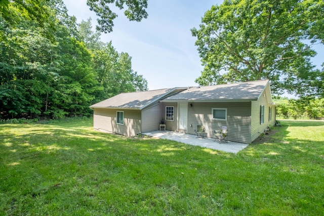 10456 Ferris Ave, Grant, MI 49327 - rear view of house featuring a patio and a lawn