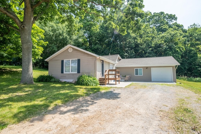 10456 Ferris Ave, Grant, MI 49327 - view of front of house featuring dirt driveway, an outdoor structure, a front lawn, and a garage