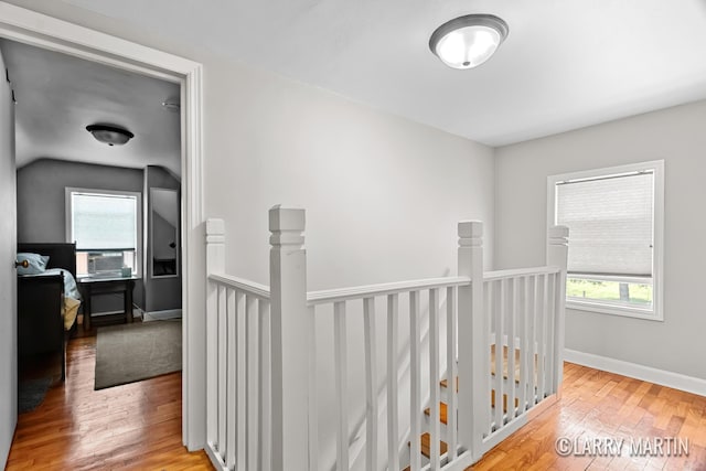 1426 Lancashire SE, Grand Rapids, MI 49508 - hall featuring an upstairs landing, plenty of natural light, light wood-type flooring, vaulted ceiling, and cooling unit