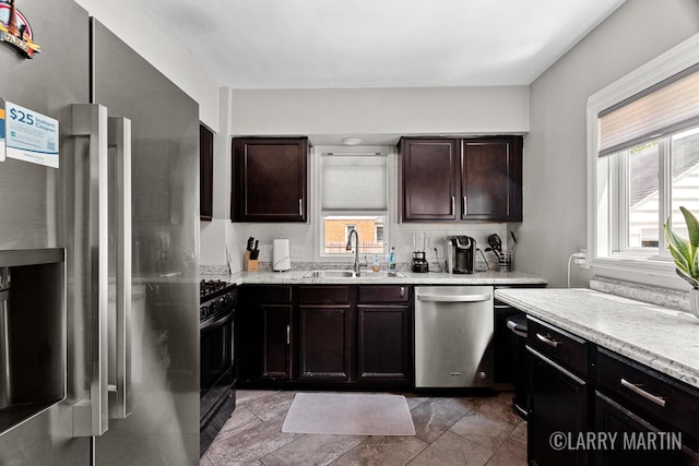 1426 Lancashire SE, Grand Rapids, MI 49508 - kitchen featuring appliances with stainless steel finishes, decorative backsplash, dark brown cabinetry, and stone finish floors