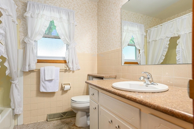 18169 6th Avenue Rd, Three Rivers, MI 49093 - bathroom with tile walls, vanity, wainscoting, and wallpapered walls