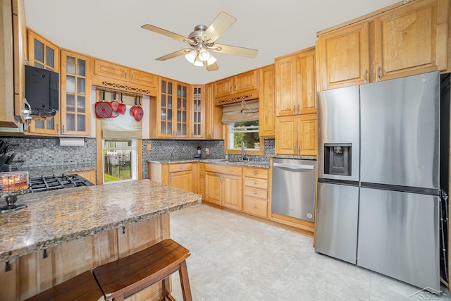8603 Millington Rd, Vassar, MI 48768 - kitchen with stainless steel appliances, a ceiling fan, decorative backsplash, and glass insert cabinets