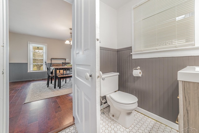 8603 Millington Rd, Vassar, MI 48768 - bathroom with a wainscoted wall, hardwood / wood-style flooring, wood walls, and vanity