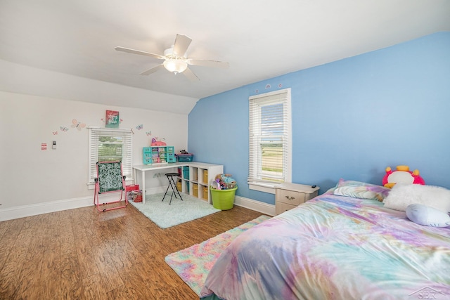 8603 Millington Rd, Vassar, MI 48768 - bedroom with multiple windows, vaulted ceiling, wood finished floors, and ceiling fan