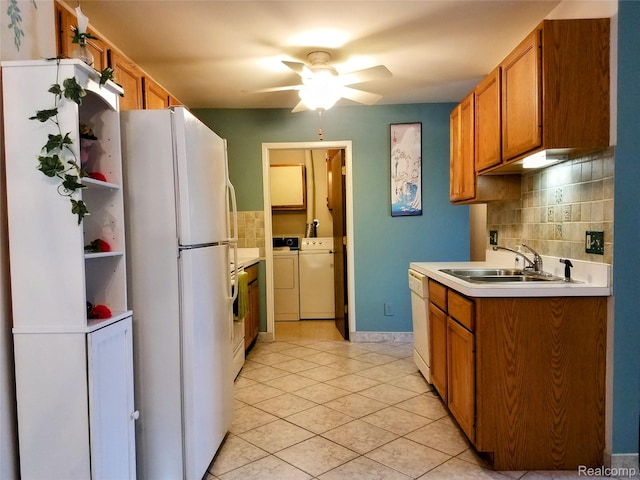 50102 S Benny Ct, New Baltimore, MI 48047 - kitchen featuring white appliances, washing machine and clothes dryer, a ceiling fan, decorative backsplash, and light tile patterned flooring