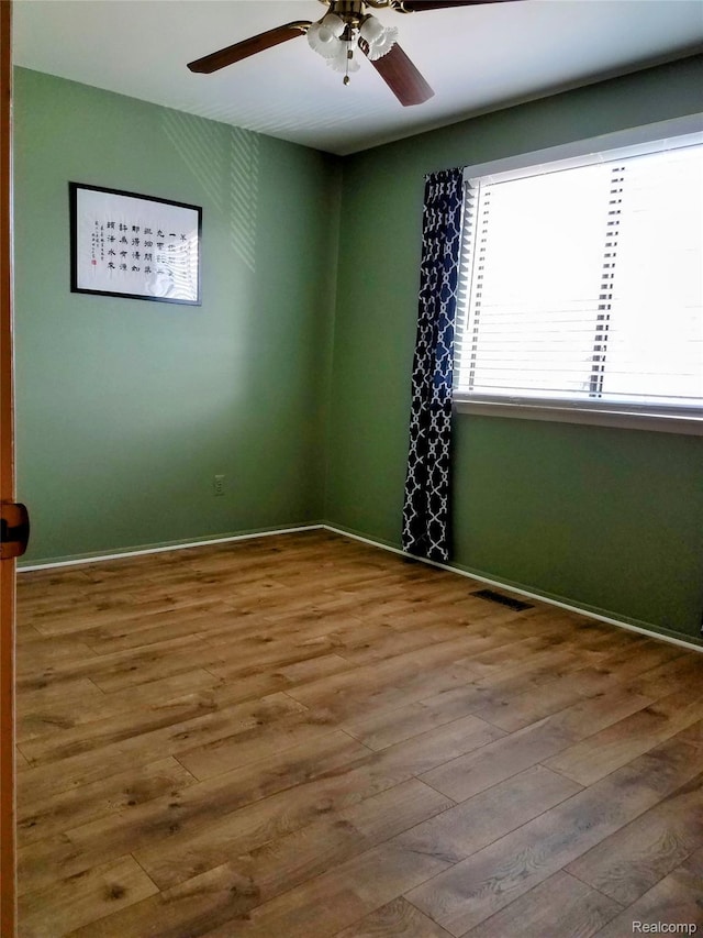 50102 S Benny Ct, New Baltimore, MI 48047 - spare room with a ceiling fan and wood finished floors