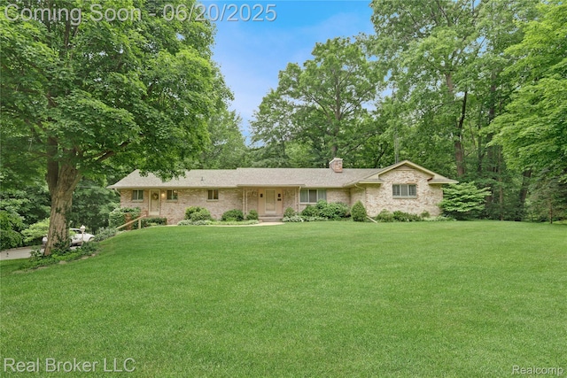 5492 N Sycamore Dr, Burton, MI 48509 - ranch-style house with a chimney, a front lawn, and brick siding