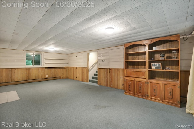 5492 N Sycamore Dr, Burton, MI 48509 - unfurnished living room with carpet, wood walls, and stairs