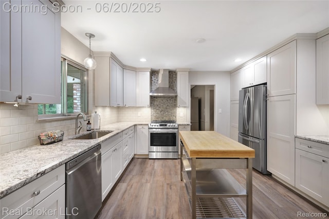 5492 N Sycamore Dr, Burton, MI 48509 - kitchen with stainless steel appliances, wall chimney range hood, dark wood-type flooring, wooden counters, and backsplash