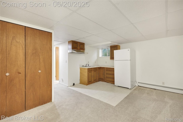 5492 N Sycamore Dr, Burton, MI 48509 - kitchen featuring freestanding refrigerator, brown cabinets, light colored carpet, a baseboard radiator, and light countertops