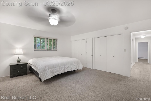 5492 N Sycamore Dr, Burton, MI 48509 - bedroom featuring carpet flooring, multiple closets, a baseboard radiator, and a ceiling fan