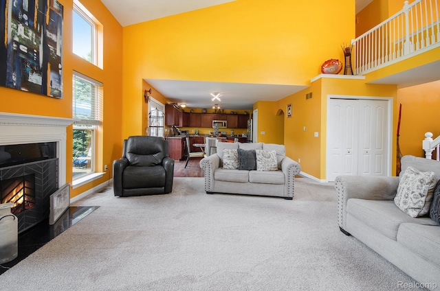 15740 Aspen Dr, Romulus, MI 48174 - living room with a towering ceiling, carpet floors, and a fireplace with flush hearth