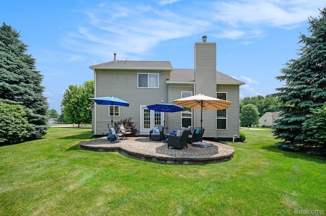 15740 Aspen Dr, Romulus, MI 48174 - back of property with a patio area, a chimney, and a lawn